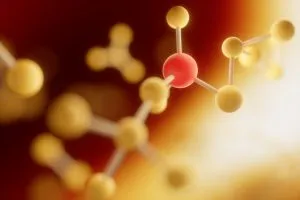 Estrutura molecular com esferas amarelas e vermelhas ligadas por barras brancas